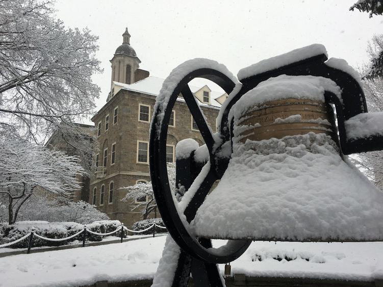 Snow falls on Old Main bell